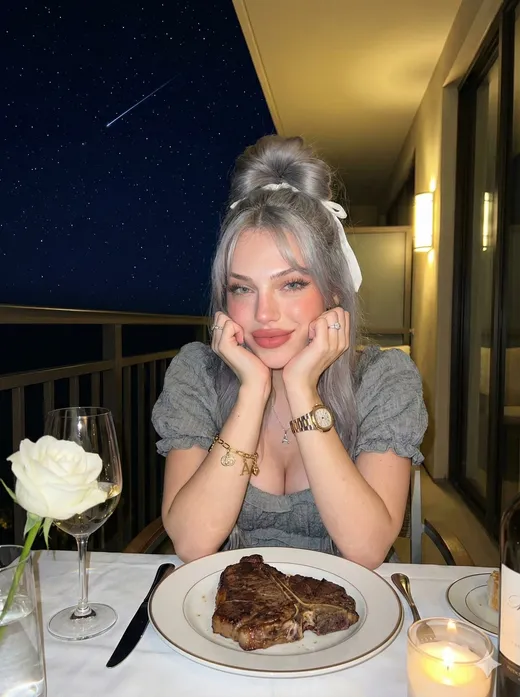 Silver-haired fictional AI character at dinner