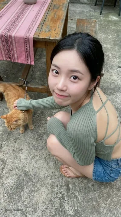 Dark-haired fictional AI character spending time with a cat